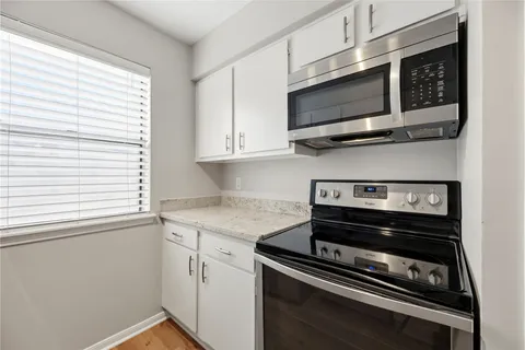 a kitchen with a stove and a microwave