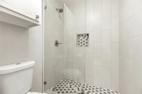 a bathroom with a shower and a toilet
