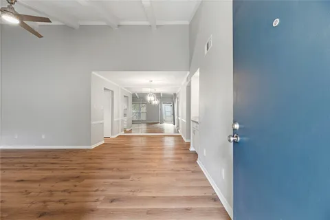a view of a room with wooden floor and staircase