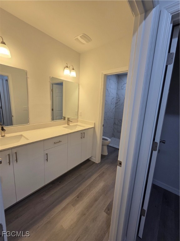 15 Hampton Avenue Lehigh Acres, FL 33936 - Photo 11 of 14 a spacious bathroom with a double vanity sink a mirror and a shower