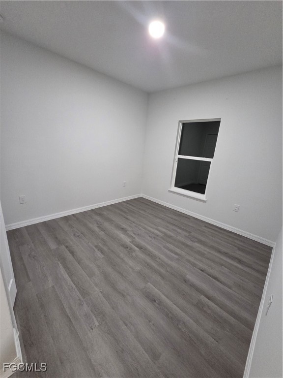 15 Hampton Avenue Lehigh Acres, FL 33936 - Photo 12 of 14 an empty room with wooden floor and windows