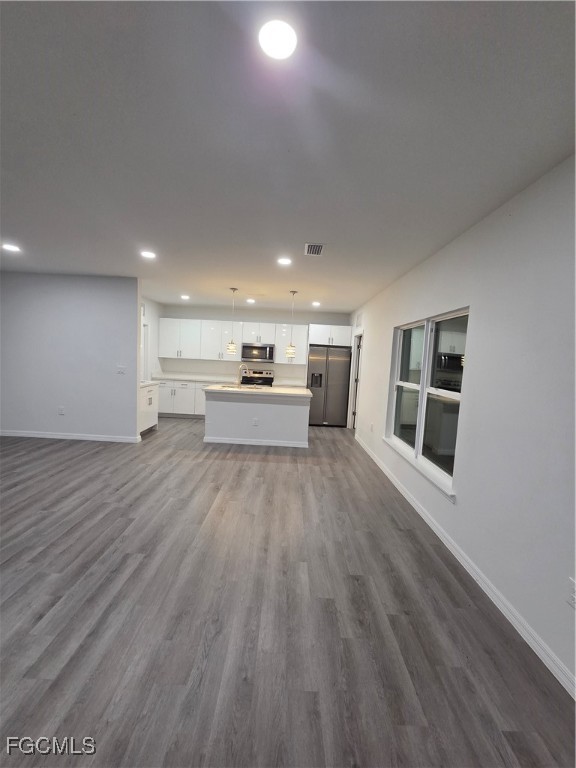 15 Hampton Avenue Lehigh Acres, FL 33936 - Photo 7 of 14 a view of kitchen and hall with wooden floor