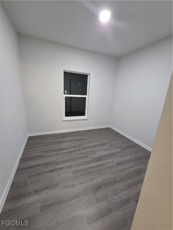 15 Hampton Avenue Lehigh Acres, FL 33936 - Photo 10 of 14 a view of an empty room with wooden floor and a window