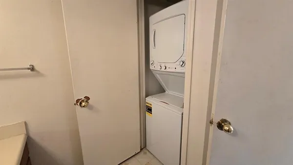 a bathroom with a granite countertop toilet and sink