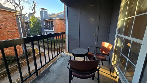 a balcony view with a seating space