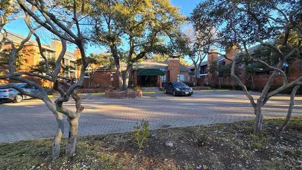 a view of a house with large trees