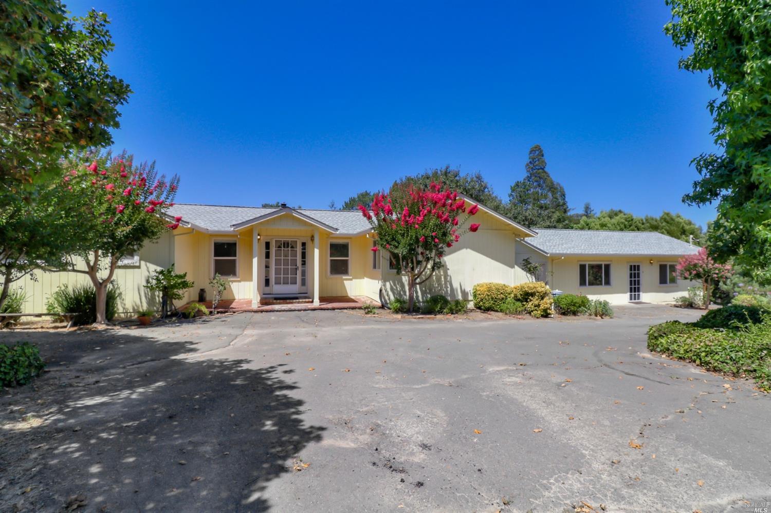 7990 Kennedy Road Sebastopol, CA 95472 - Photo 1 of 1 a front view of a house with a yard and garage