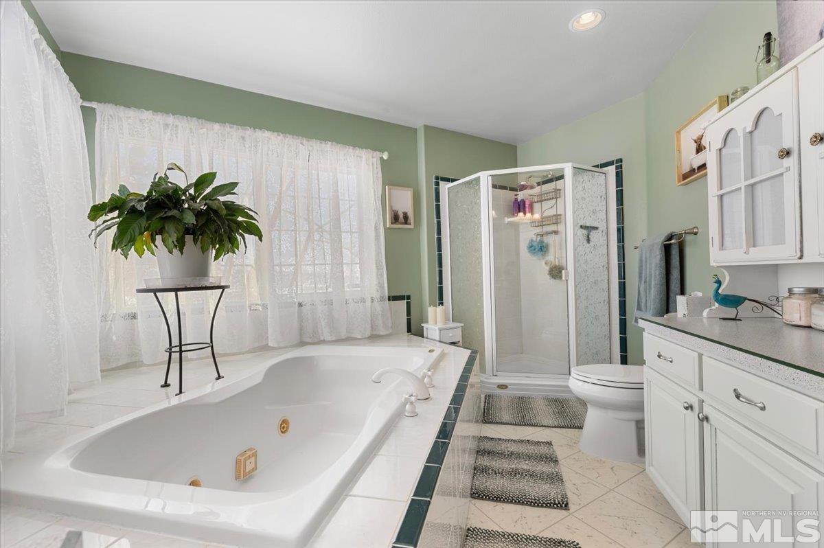 12803 North Red Rock Road Reno, NV 89508 - Photo 17 of 40 a bathroom with a bathtub sink and toilet