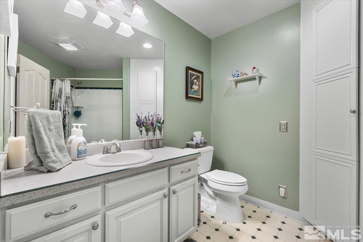 12803 North Red Rock Road Reno, NV 89508 - Photo 25 of 40 a bathroom with a sink a toilet and shower