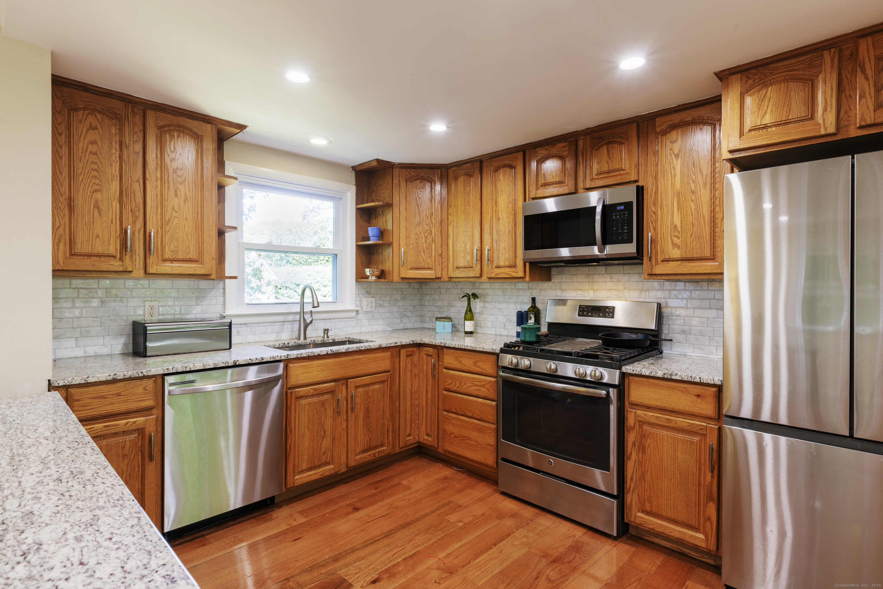 239 A Rockledge Road Lyme, CT 06371 - Photo 10 of 30 a kitchen with stainless steel appliances granite countertop a stove top oven a sink dishwasher a refrigerator and a microwave