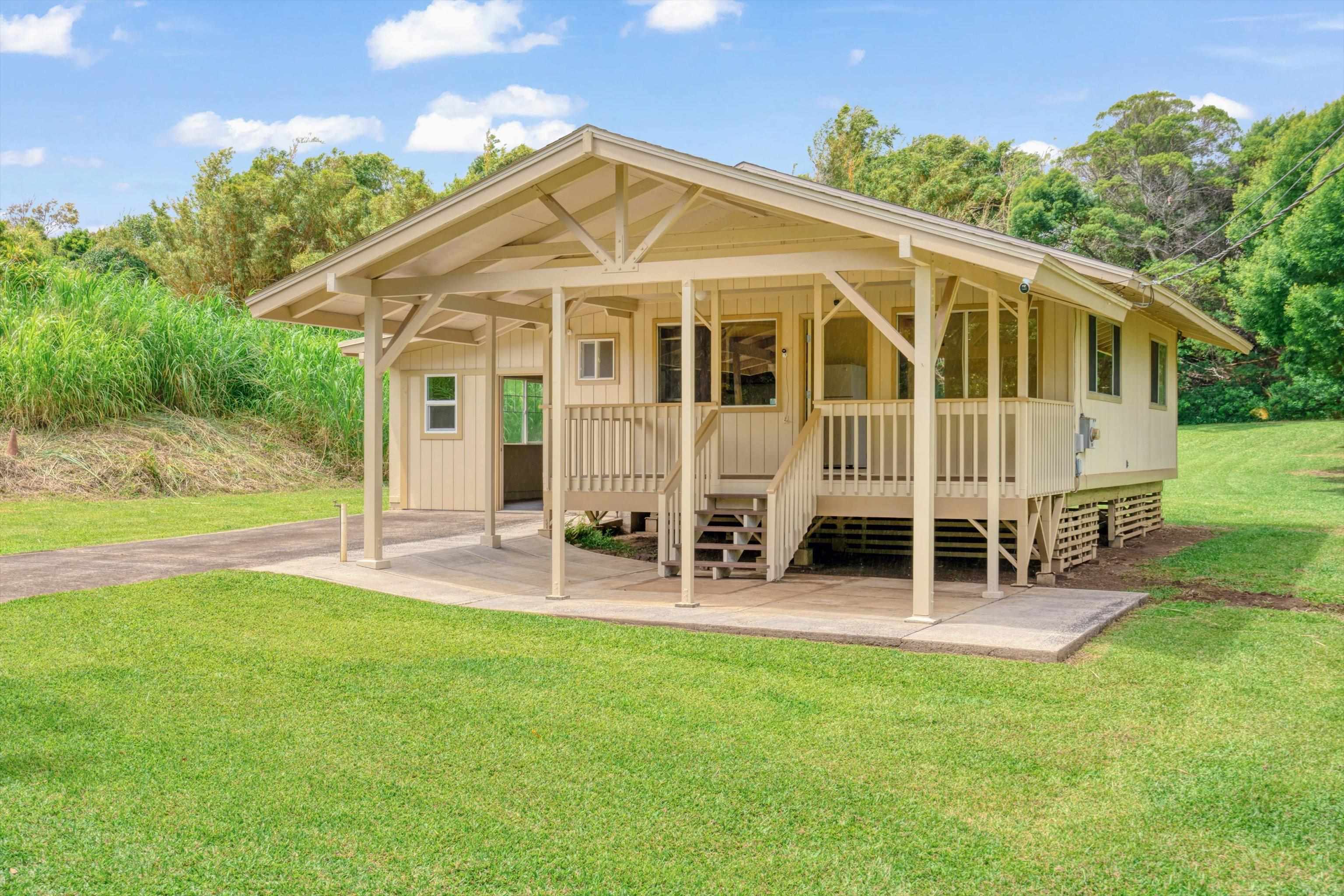 1784 West Kuiaha Road Haiku, HI 96708 - Photo 20 of 27 a view of a house with a yard and sitting area