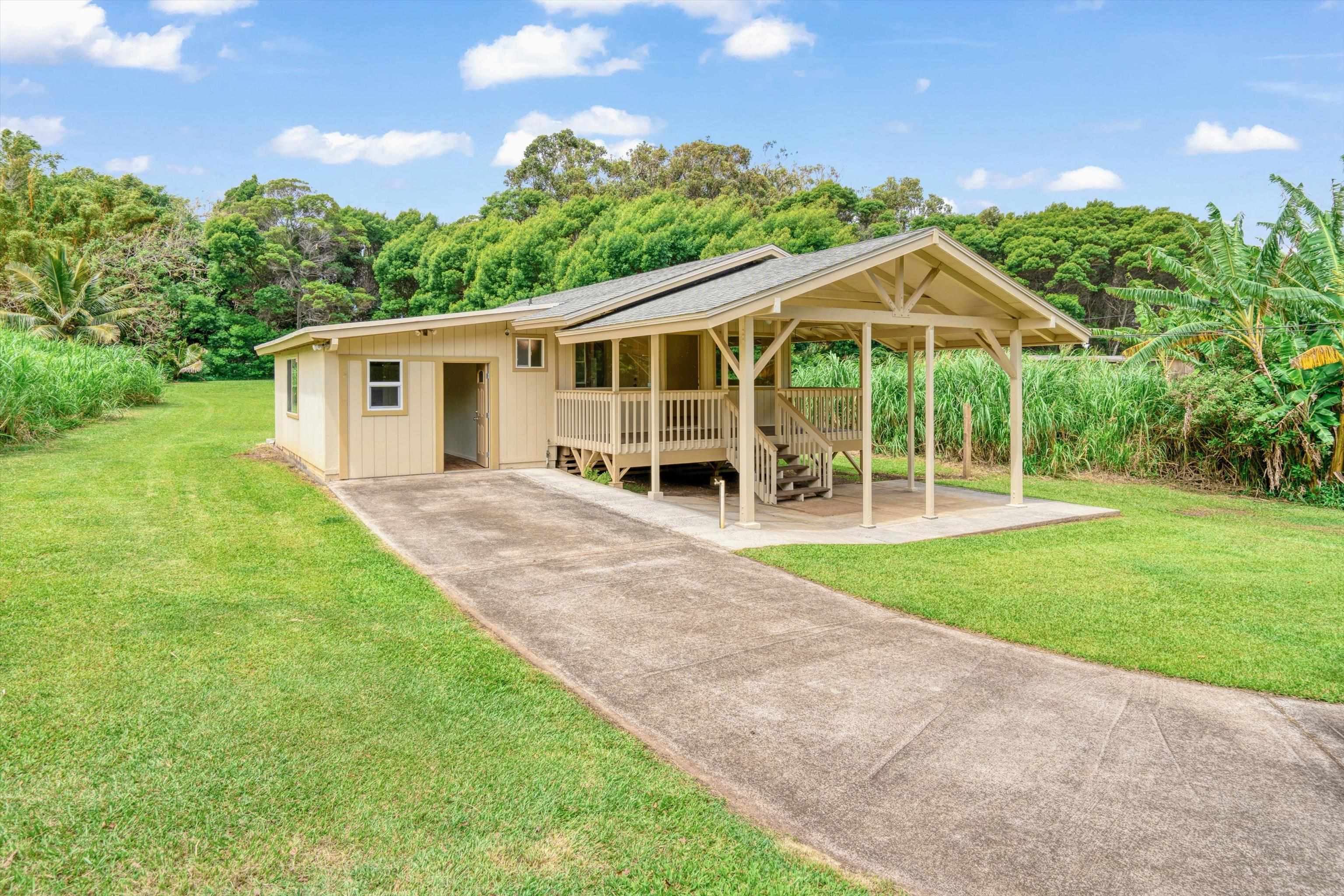 1784 West Kuiaha Road Haiku, HI 96708 - Photo 6 of 27 front view of a house with a yard