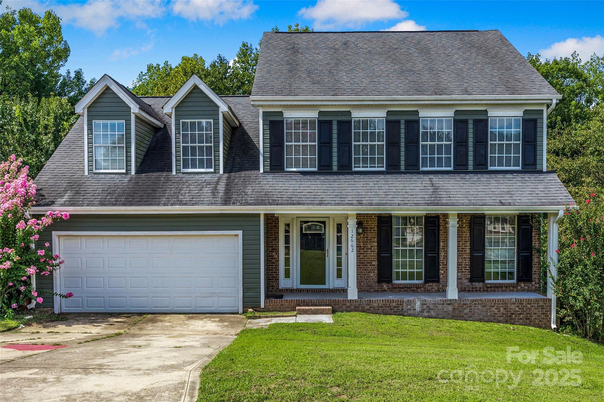 12662 Woodside Falls Road Pineville, NC 28134 - Photo 1 of 47 a front view of a house with a yard and garage
