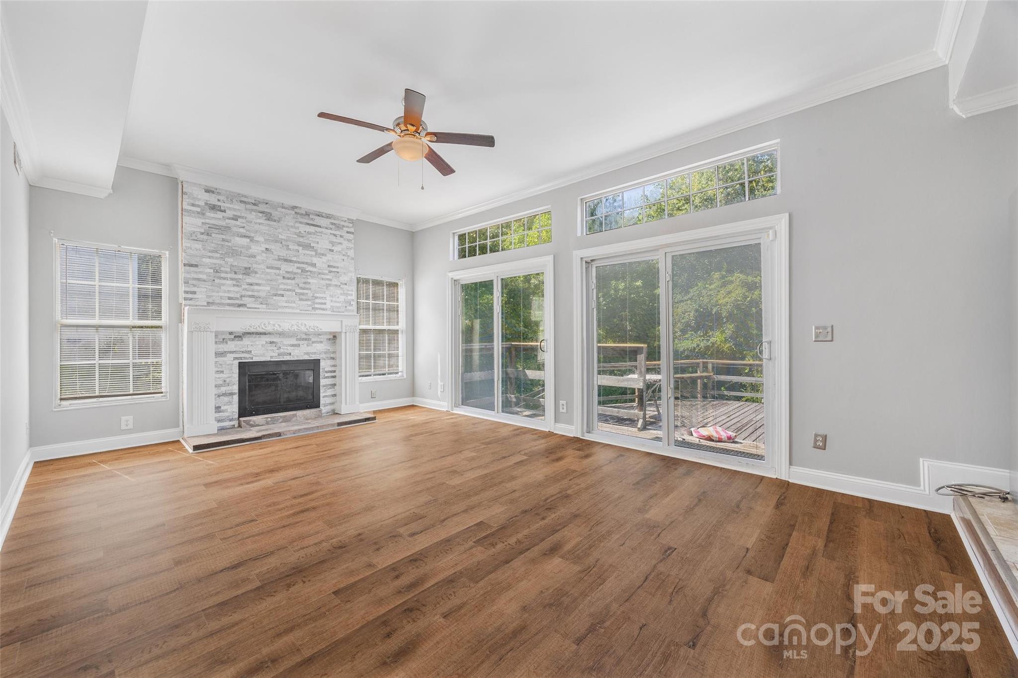 12662 Woodside Falls Road Pineville, NC 28134 - Photo 13 of 47 a view of an empty room with wooden floor and a fireplace