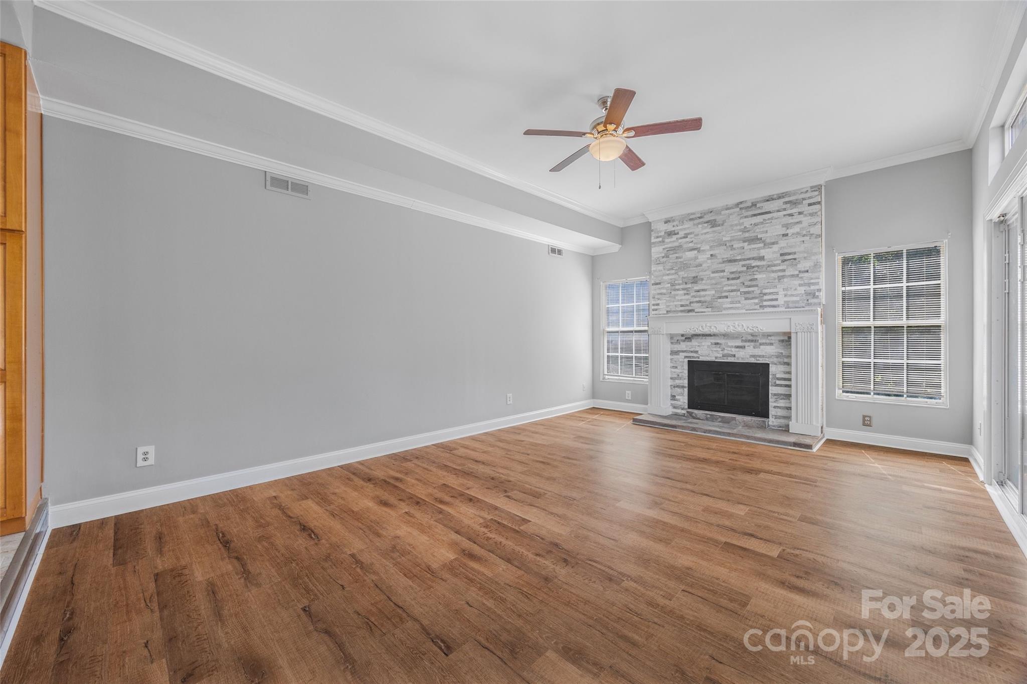 12662 Woodside Falls Road Pineville, NC 28134 - Photo 15 of 47 a view of empty room with wooden floor and fireplace