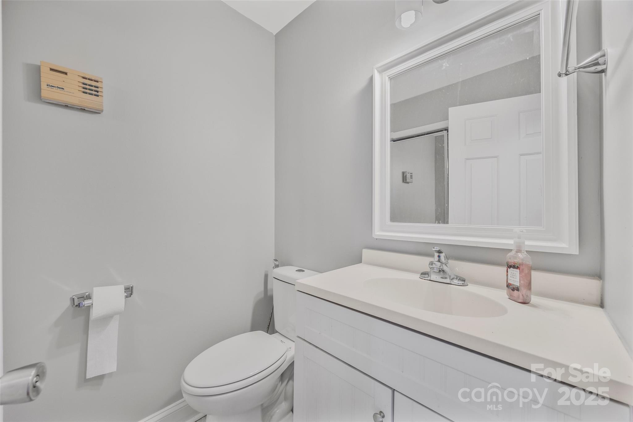 12662 Woodside Falls Road Pineville, NC 28134 - Photo 16 of 47 a bathroom with a sink a toilet and a mirror