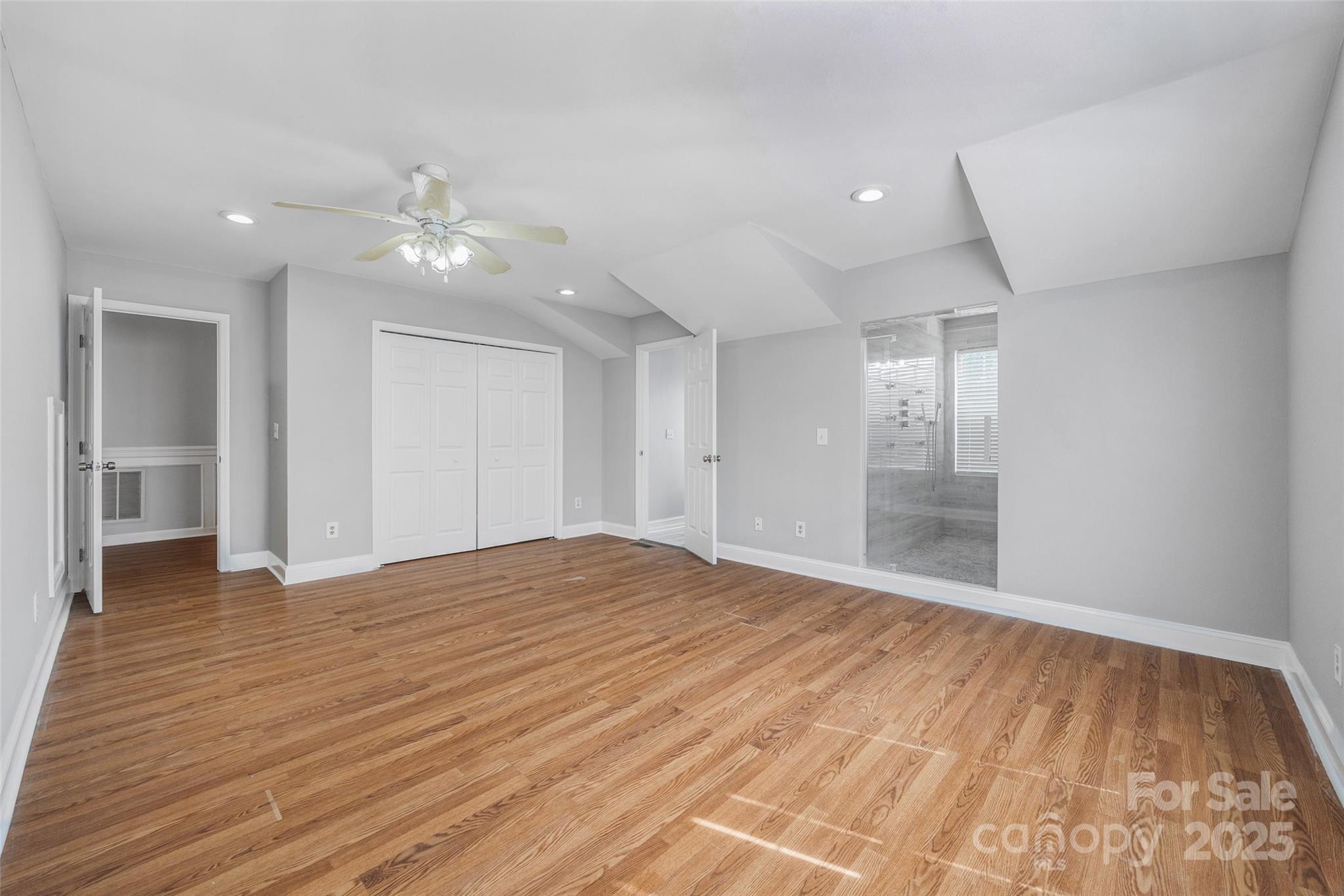 12662 Woodside Falls Road Pineville, NC 28134 - Photo 25 of 47 a view of empty room with wooden floor and fan