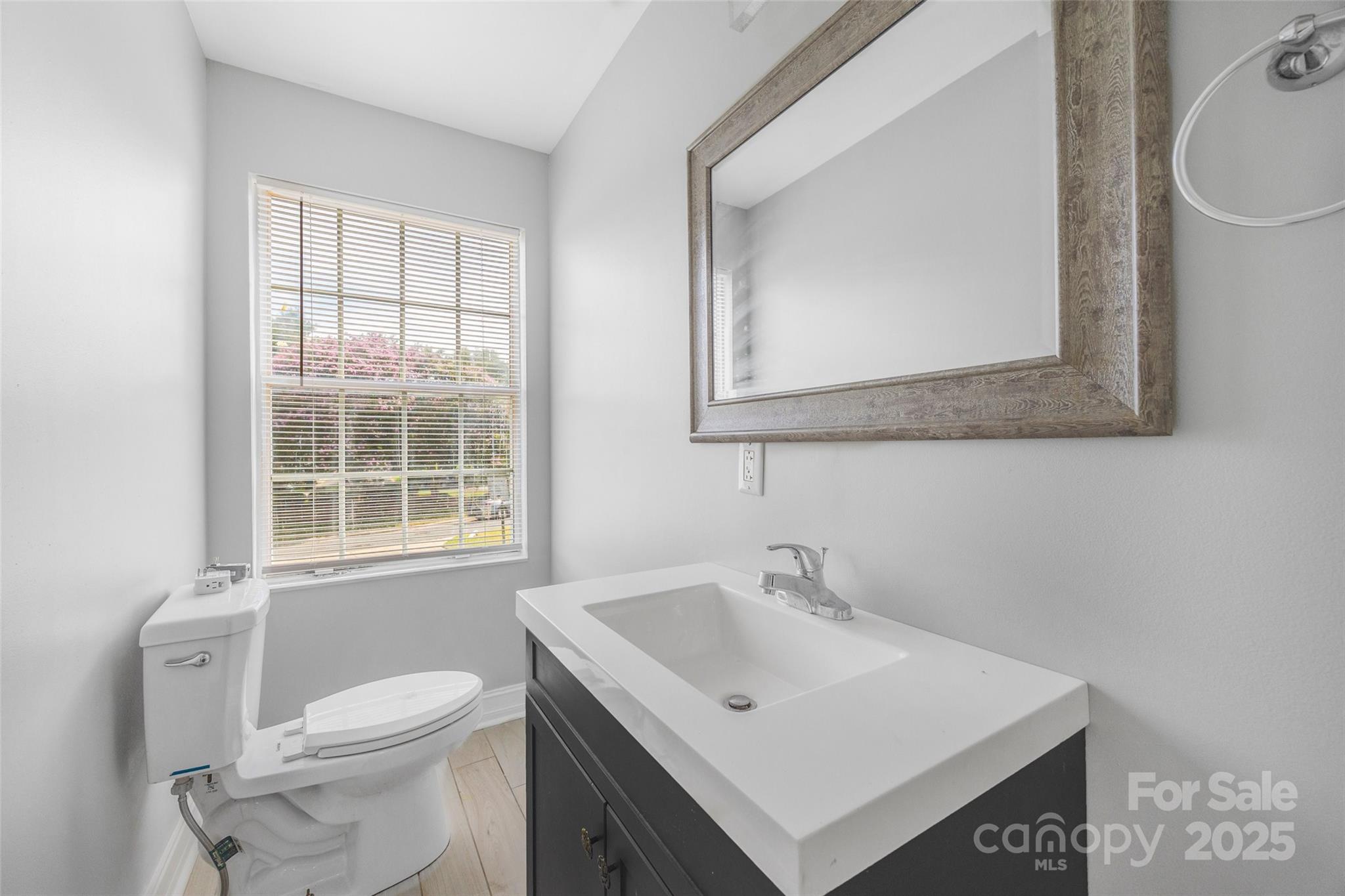 12662 Woodside Falls Road Pineville, NC 28134 - Photo 26 of 47 a bathroom with a sink a toilet and a window