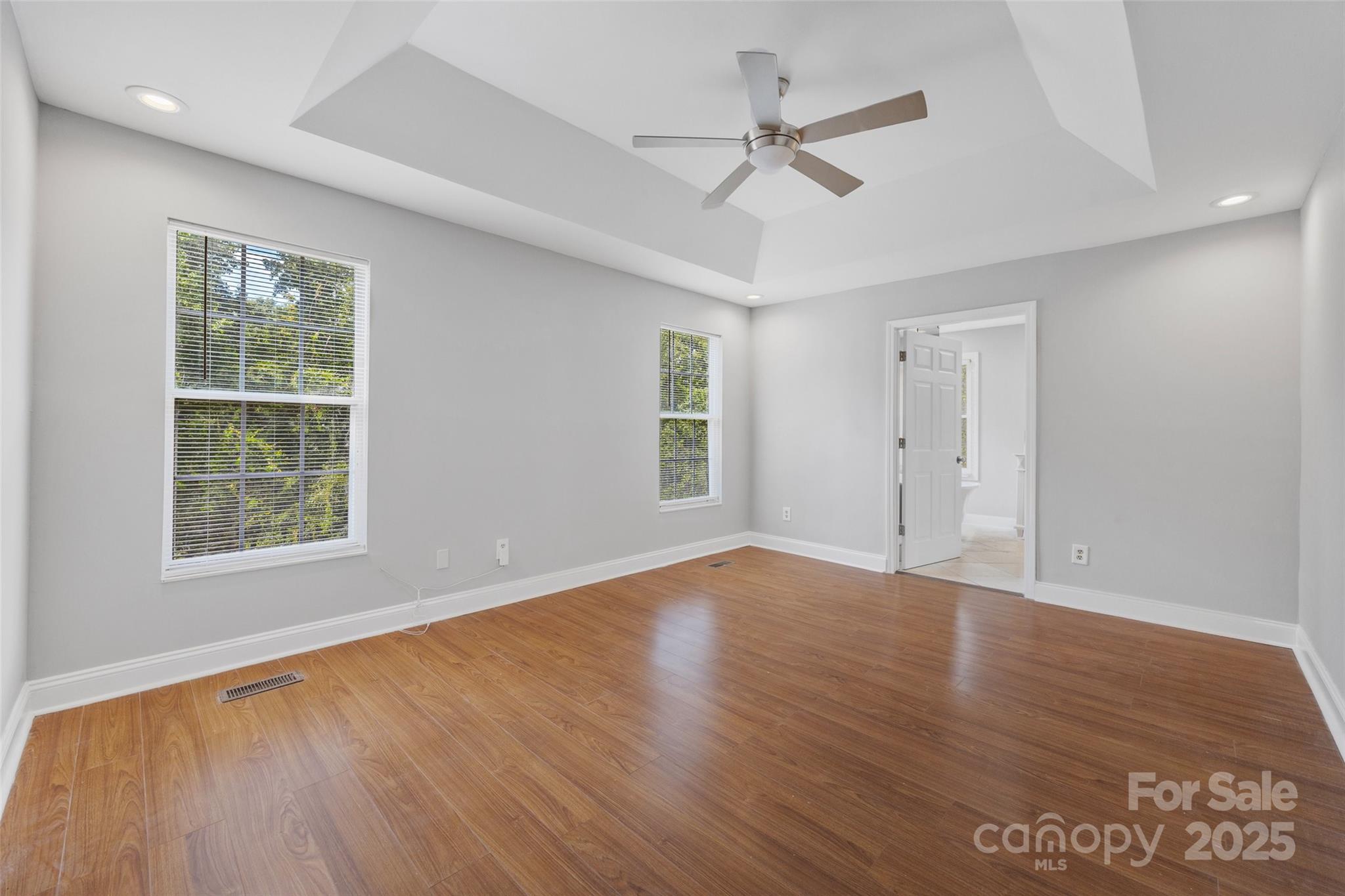 12662 Woodside Falls Road Pineville, NC 28134 - Photo 28 of 47 a view of an empty room with wooden floor and a window