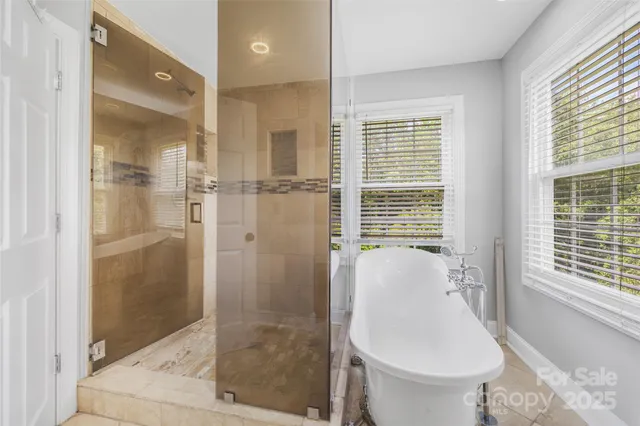 a view of a room with wooden floor and bathroom view