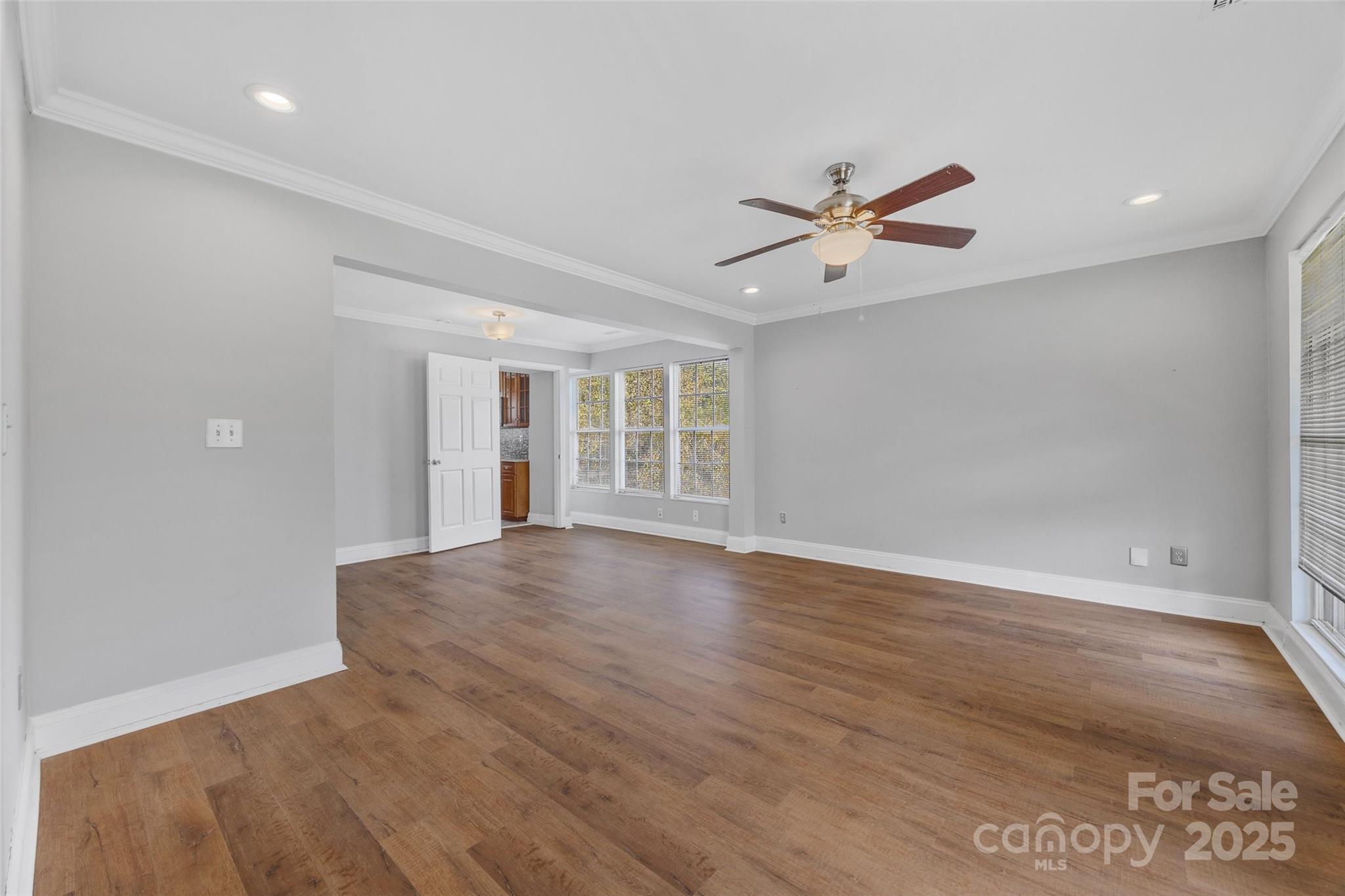 12662 Woodside Falls Road Pineville, NC 28134 - Photo 4 of 47 wooden floor in an empty room with a window