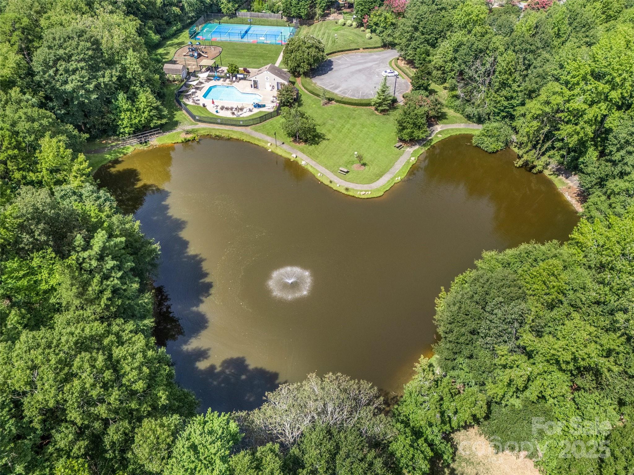 12662 Woodside Falls Road Pineville, NC 28134 - Photo 41 of 47 an aerial view of a house with a lake view