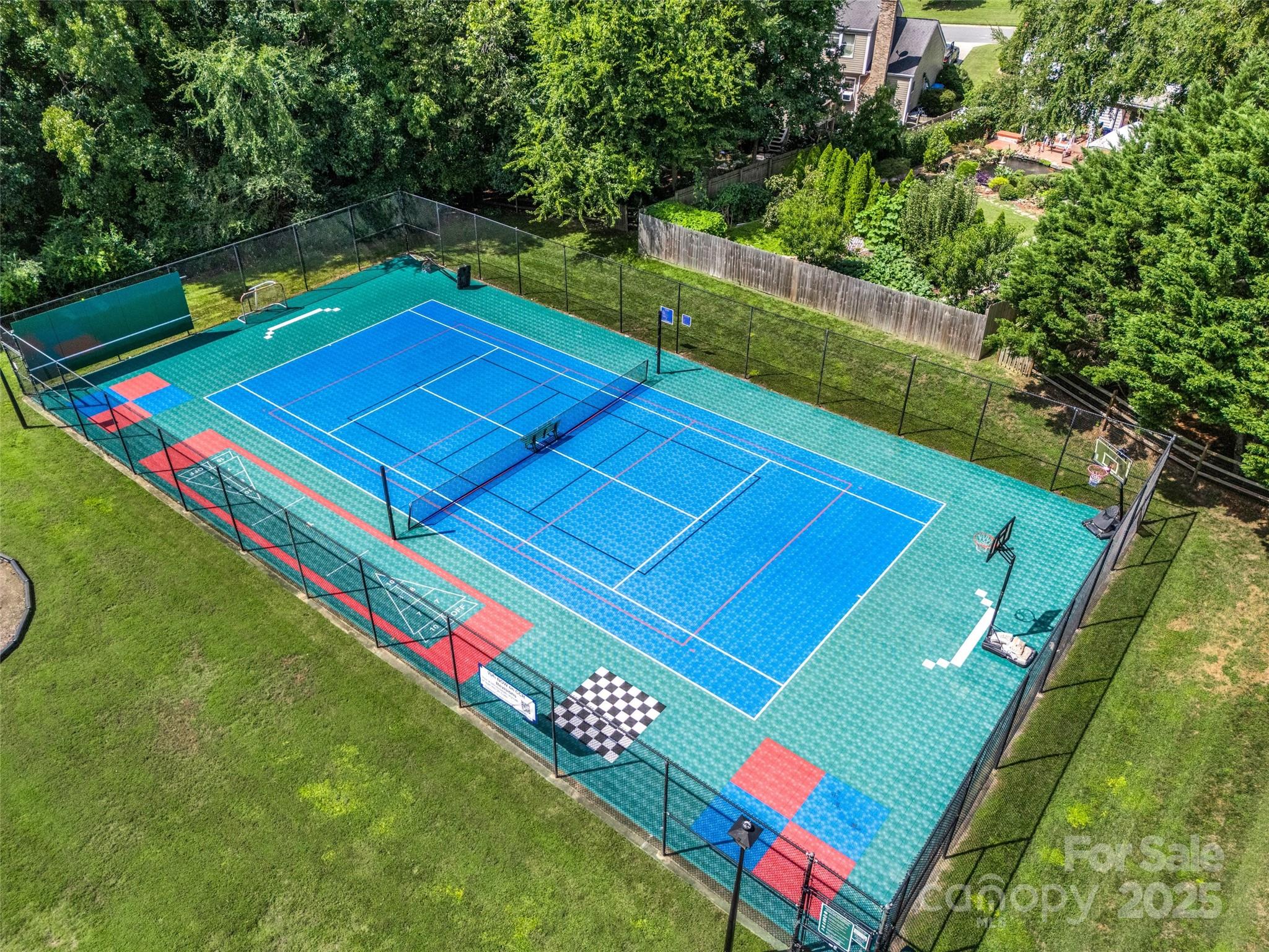 12662 Woodside Falls Road Pineville, NC 28134 - Photo 46 of 47 a view of a tennis ground with large trees