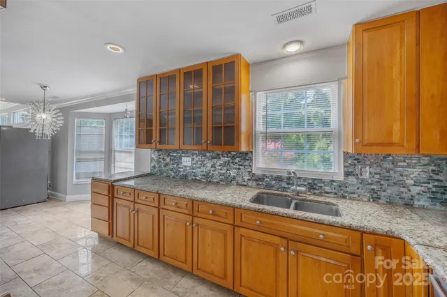 a kitchen that has a sink and a stove