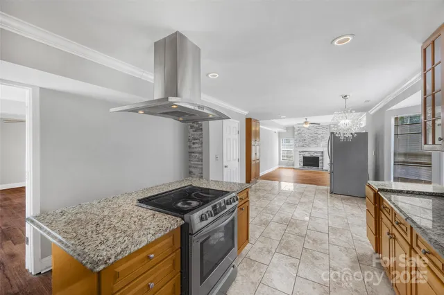a kitchen with stainless steel appliances granite countertop a sink and a granite counter tops