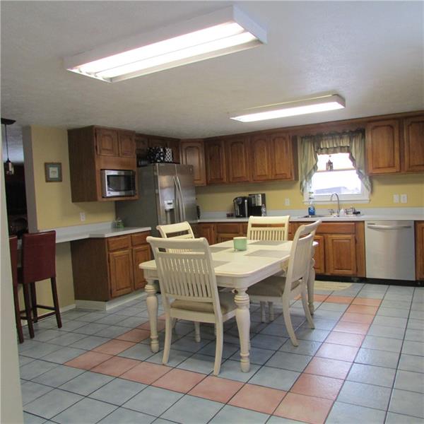This is a fantastic kitchen. Lots of cabinets and counter top for work area. Newer appliances. Eat in area and bar area with chairs. 