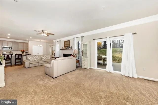 a living room with furniture and kitchen view