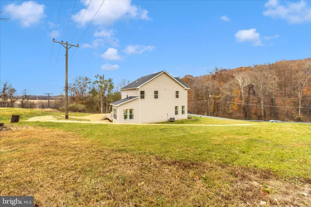 a view of a large pool with an outdoor space and seating area