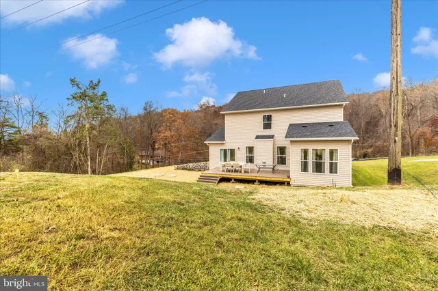 a view of a house with a yard covered with snow in the background