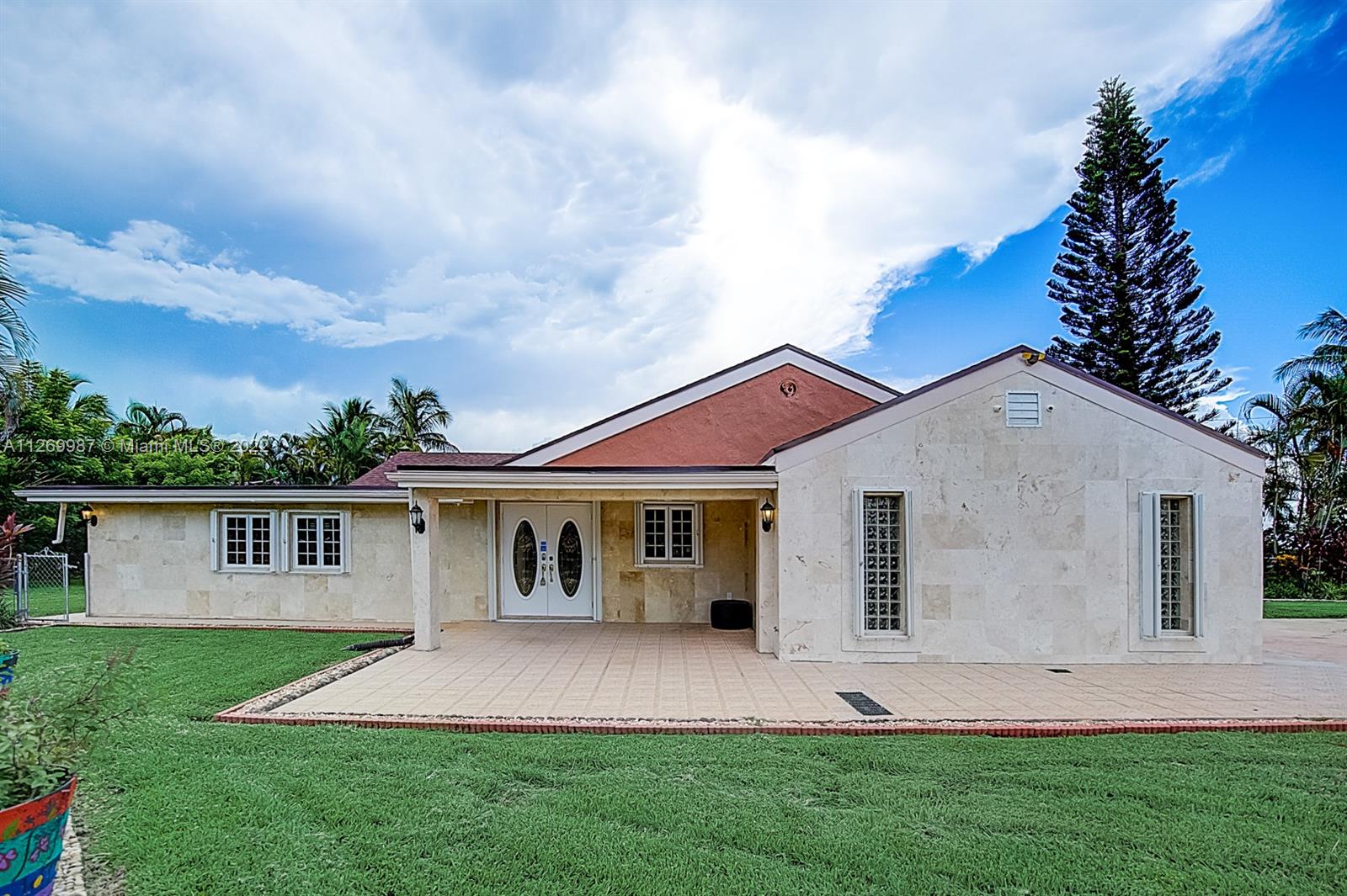 15540 Southwest 156th Avenue Miami, FL 33187 - Photo 1 of 37 front view of a house with a yard