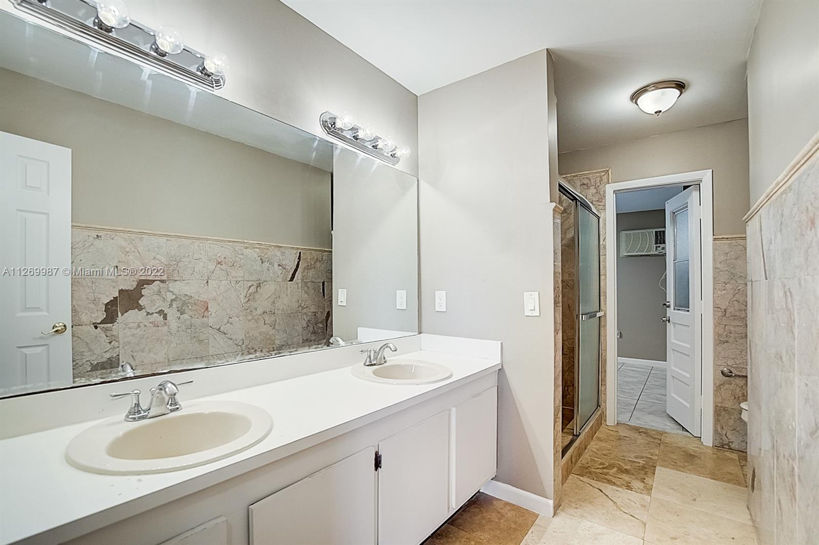 15540 Southwest 156th Avenue Miami, FL 33187 - Photo 29 of 37 a bathroom with a sink double vanity and a mirror