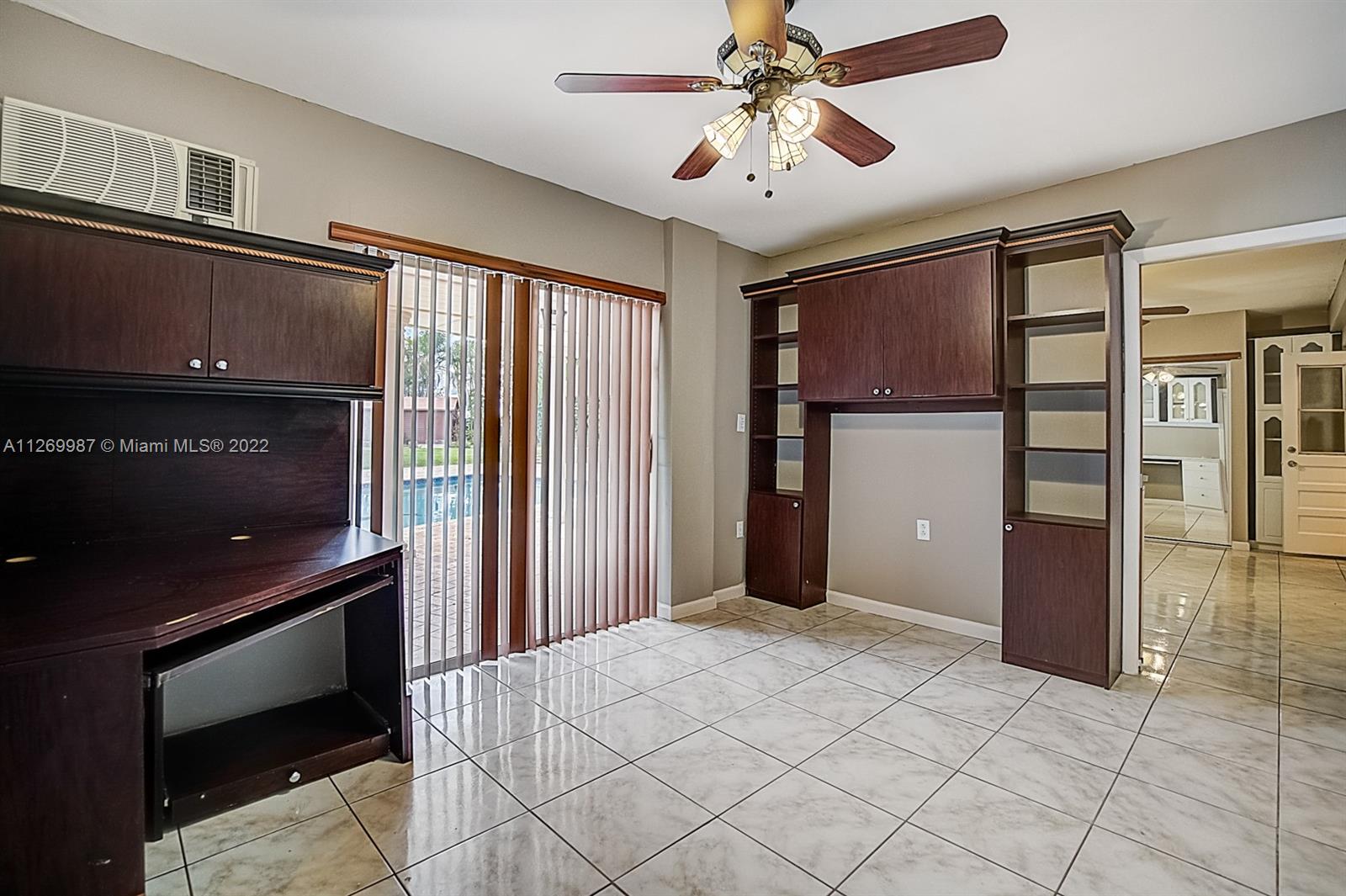 15540 Southwest 156th Avenue Miami, FL 33187 - Photo 34 of 37 a bedroom with a bed and a chandelier