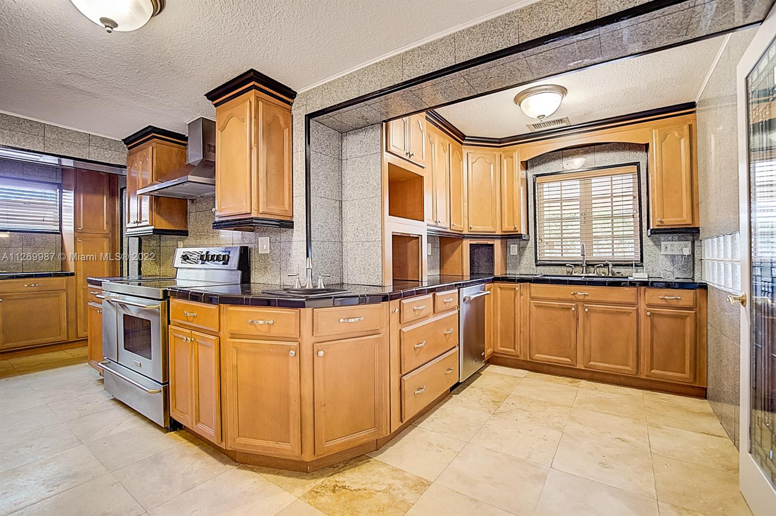 15540 Southwest 156th Avenue Miami, FL 33187 - Photo 4 of 37 a kitchen with stainless steel appliances granite countertop a sink and cabinets