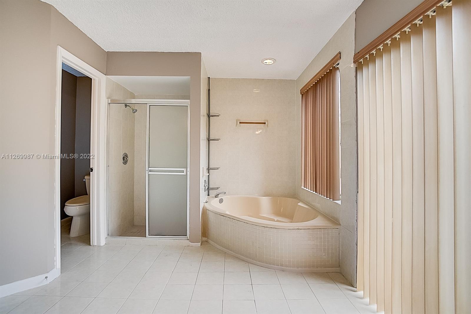 15540 Southwest 156th Avenue Miami, FL 33187 - Photo 8 of 37 a bathroom with a bathtub and shower