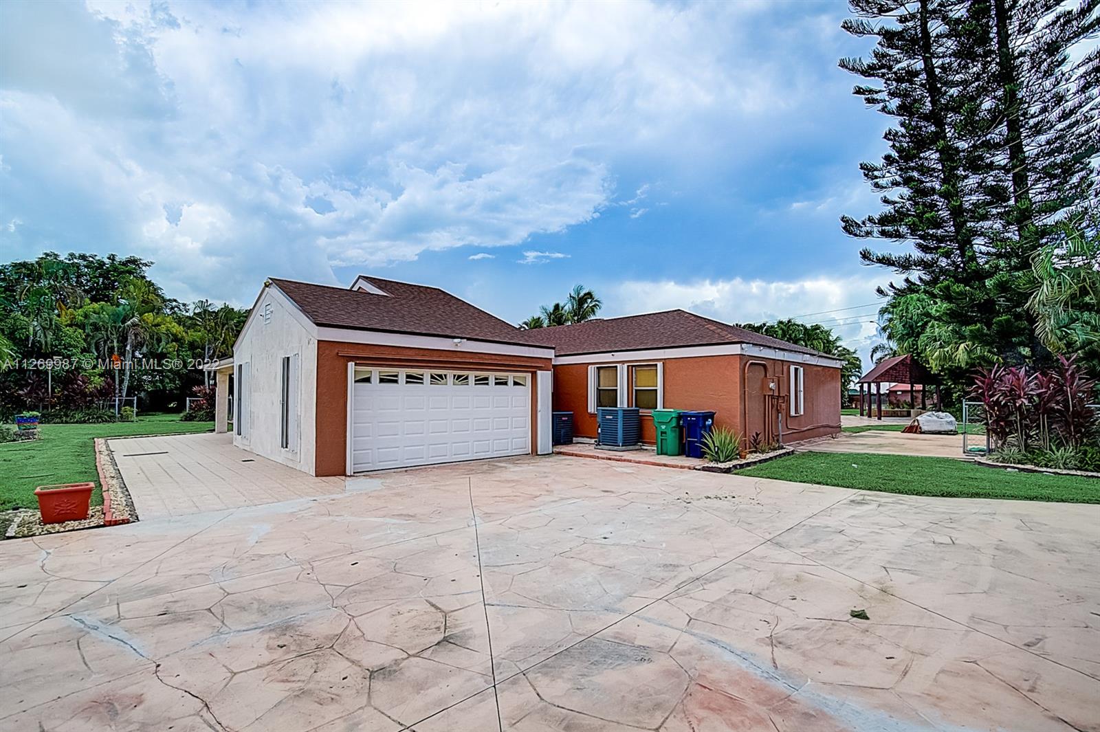 15540 Southwest 156th Avenue Miami, FL 33187 - Photo 10 of 37 a front view of a house with a yard and trees
