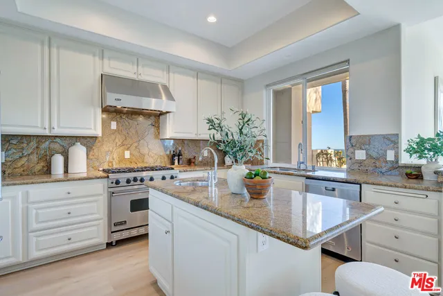a kitchen with sink stove and cabinets