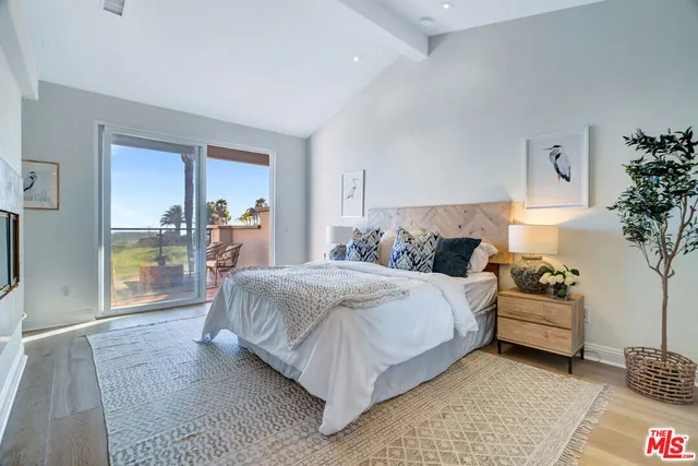 a bedroom with a large bed and a window