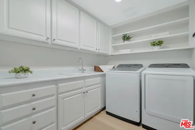 a utility room with closet dryer and washer