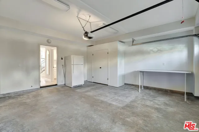 an empty room with a windows and dryer