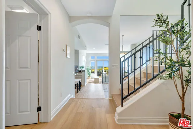 a view of entryway and hall with wooden floor