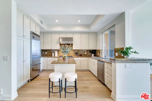 a kitchen with white cabinets and white appliances