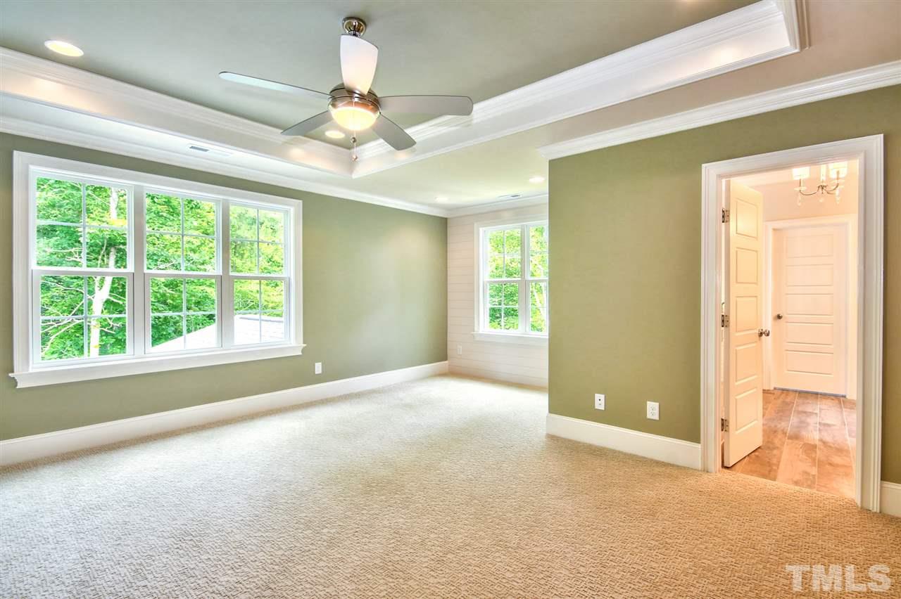 116 Roseroot Court Holly Springs, NC 27540 - Photo 11 of 25 Sprawling Master Suite with sitting area, tray ceiling and shiplap accented wall!