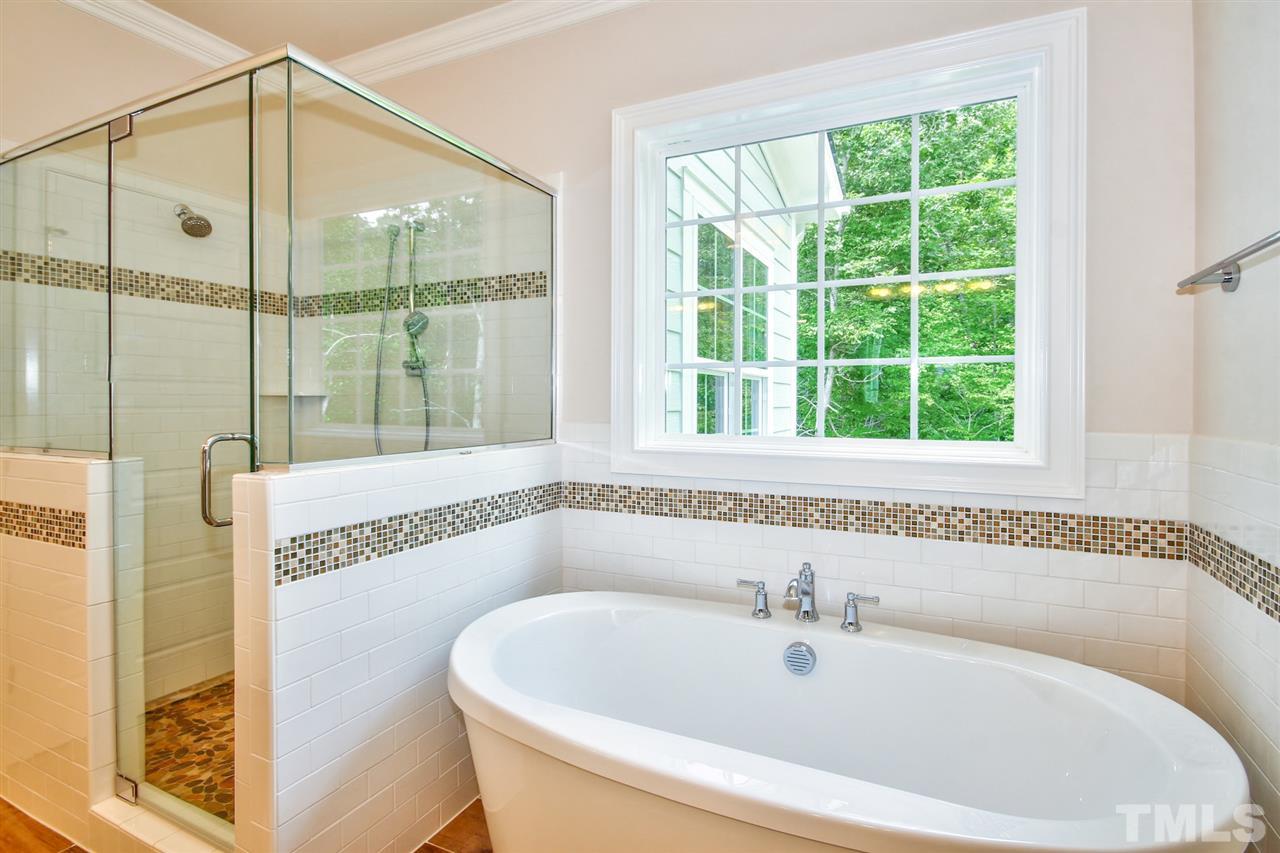 116 Roseroot Court Holly Springs, NC 27540 - Photo 12 of 25 Delightful spa-inspired Master Bath with separate vanities, large custom multi-head tile shower and free-standing tub!