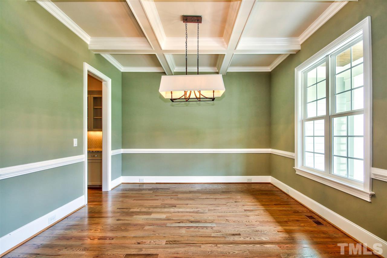 116 Roseroot Court Holly Springs, NC 27540 - Photo 3 of 25 Elegant formal Dining Room boasts impressive millwork highlighted by a coffered ceiling.
