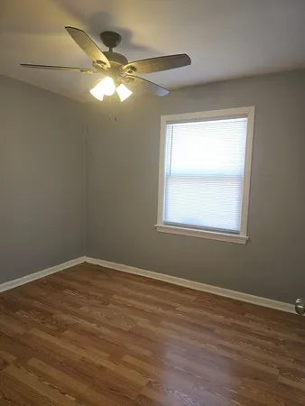 a view of wooden floor and windows in a room