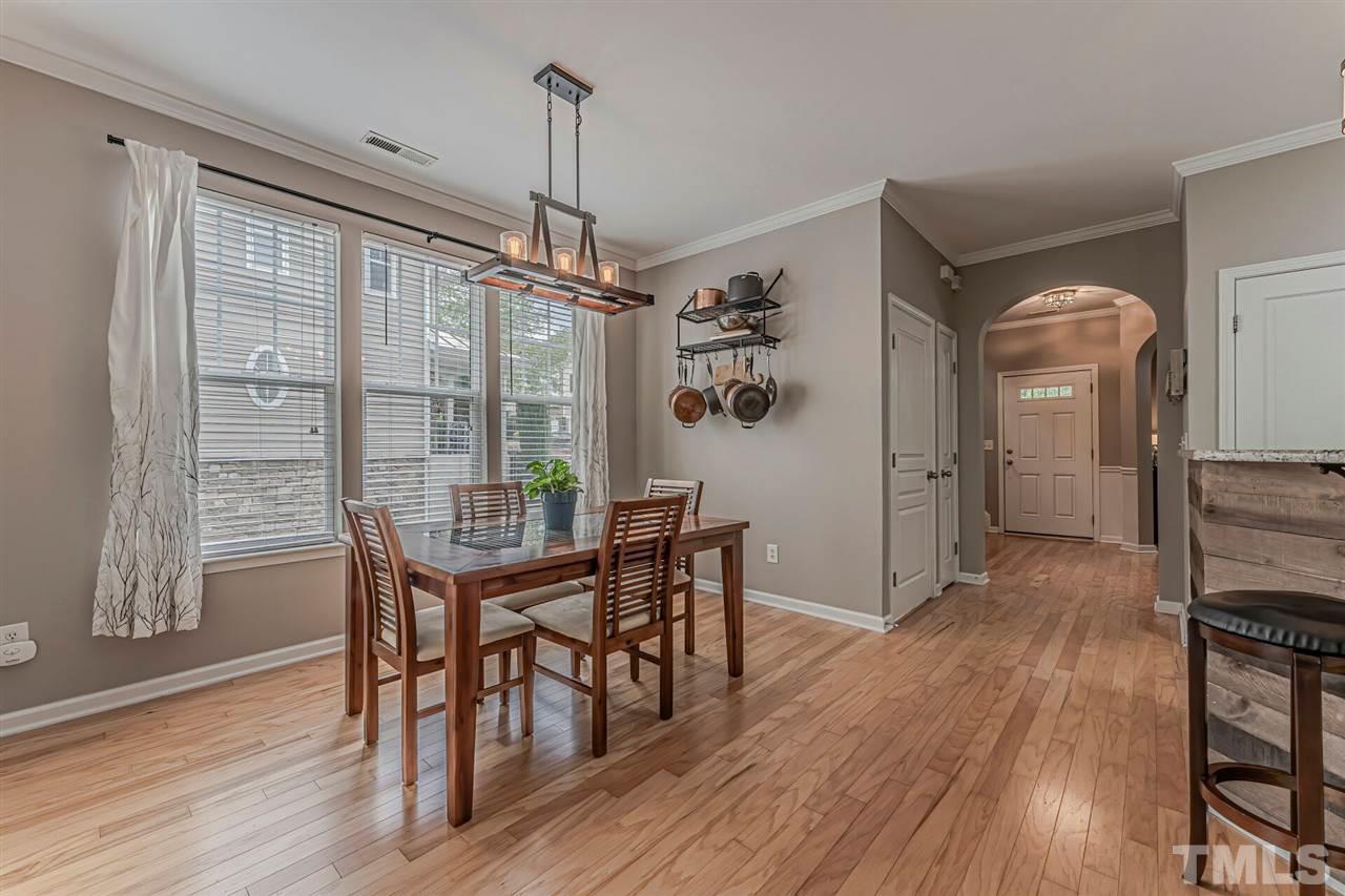 5903 Hourglass Court Raleigh, NC 27612 - Photo 12 of 29 a view of a dining room with furniture window and wooden floor